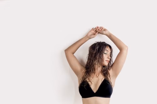 A woman exploring her body and sexual wellness with confidence.