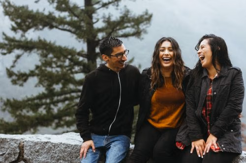 Three people in a committed throuple relationship sharing a moment of connection.